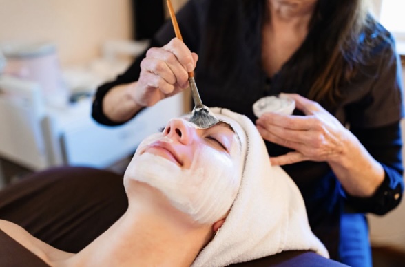 Woman receiving a relaxing facial treatment.